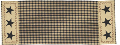 Enhance your dining decor with this charming Star Patch Table Runner! The bold black & sand plaid pattern is enhanced with a frayed homespun patch on both ends. The patch is accented with an appliqued black star surrounded by a vine-and-berry motif - a classic country design! So versatile, use throughout your home as an accent mat for you favorite candle/decorative pieces, on a mantel, or wherever your creativity leads you! 