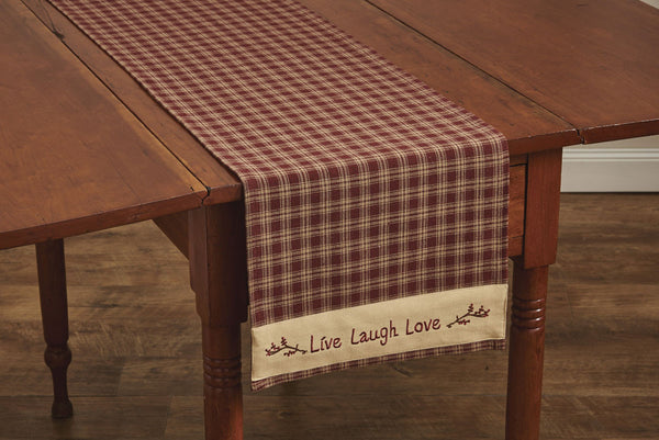 The Sturbridge Live, Laugh, Love Table Runners feature a pretty plaid of farmhouse tan & wine, and comes with a border embellished with a vine & gentle reminder to always...Live, Laugh, Love! A beautifully charming way to enhance your dining experience! 