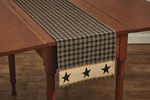 Our primitive Sturbridge Star Table Runner features a black homespun plaid pattern embellished with appliqued black stars for that classic country look! Enhance your dining experience with this reversible runner! 