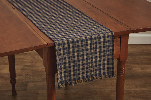 These Sturbridge Table Runners offer the perfect table covering for everyday use or for a more formal table setting!  Featuring a pretty homespun plaid in navy & farmhouse tan, it is further enhanced with a country-charming 1" fringe on each short side.