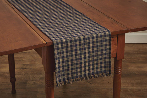 These Sturbridge Table Runners offer the perfect table covering for everyday use or for a more formal table setting!  Featuring a pretty homespun plaid in navy & farmhouse tan, it is further enhanced with a country-charming 1" fringe on each short side.These Sturbridge Table Runners offer the perfect table covering for everyday use or for a more formal table setting!  Featuring a pretty homespun plaid in navy & farmhouse tan, it is further enhanced with a country-charming 1" fringe on each short 