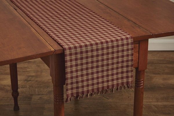 These Sturbridge Table Runners offer the perfect table covering for everyday use or for a more formal table setting! Featuring a pretty plaid in wine & farmhouse tan, it is further enhanced with a country-charming 1" fringe on each short side. So versatile, use throughout your home as an accent mat for your favorite candle/decorative pieces, on a mantel, or wherever your creativity leads you! Colors: Farmhouse Tan & Wine
