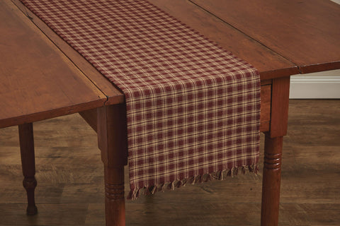 These Sturbridge Table Runners offer the perfect table covering for everyday use or for a more formal table setting! Featuring a pretty plaid in wine & farmhouse tan, it is further enhanced with a country-charming 1" fringe on each short side. So versatile, use throughout your home as an accent mat for your favorite candle/decorative pieces, on a mantel, or wherever your creativity leads you! Colors: Farmhouse Tan & Wine