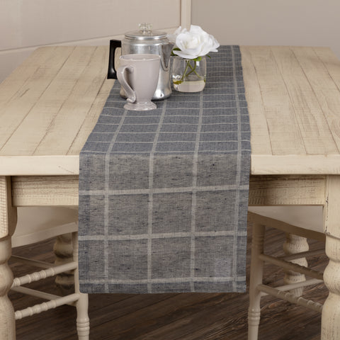 Effortlessly dress up your farmhouse table with our Julie Navy Plaid Runner 13x72. This classic table runner features a repeating windowpane woven grid, simply hemmed for a clean, finished look. Whether you're decorating the table for a special occasion or having a casual family dinner, the Julie Plaid Runner offers the perfect contemporary farmhouse feel for your kitchen.