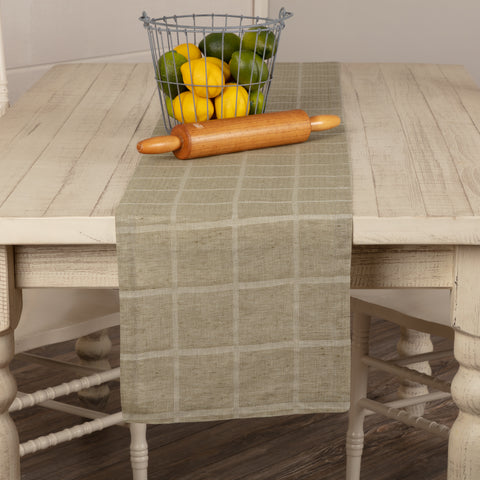 Effortlessly dress up your farmhouse table with our Julie Olive Plaid Runner 13x90. This classic table runner features a repeating windowpane woven grid, simply hemmed for a clean, finished look. Whether you're decorating the table for a special occasion or having a casual family dinner, the Julie Plaid Runner offers the perfect contemporary farmhouse feel for your kitchen.