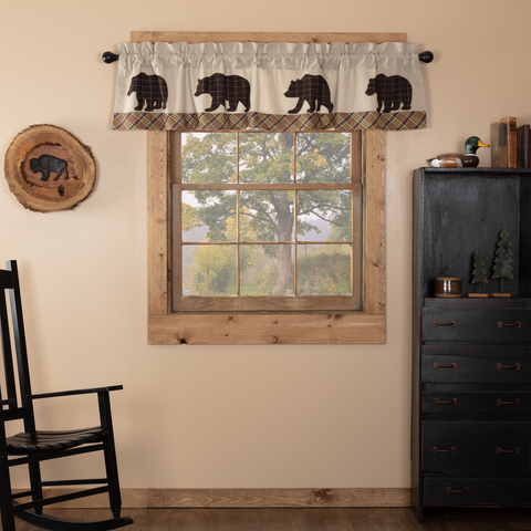 Answer the call of the wild with the rugged but stylish 16x72 Wyatt Bear Valance. Espresso brown and white windowpane plaid bear walk along its bottom.  A textured khaki chambray and crimson plaid strip along bottom helps create a cozy frame around your window's woodland vista.