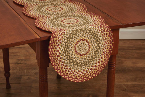 Mill Village Scalloped Braided Runner - 54"L feature a vibrant garnet, combines it with green & cream, then softens it with buttercream to make this lovely tabletop! 