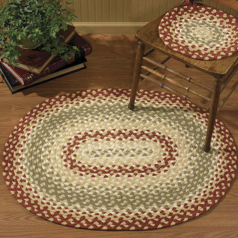 The Mill Village Braided Rug 32"x42" feature a vibrant garnet, combines it with green and cream, then softens it with buttercream to make these lovely rugs!