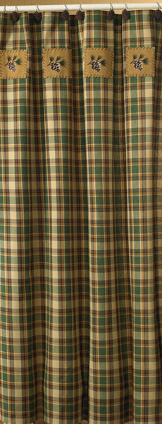 The Scotch Pine Shower Curtain features a plaid in warm shades of brown, green and dark honey with applique patches accented with embroidered pine cones.