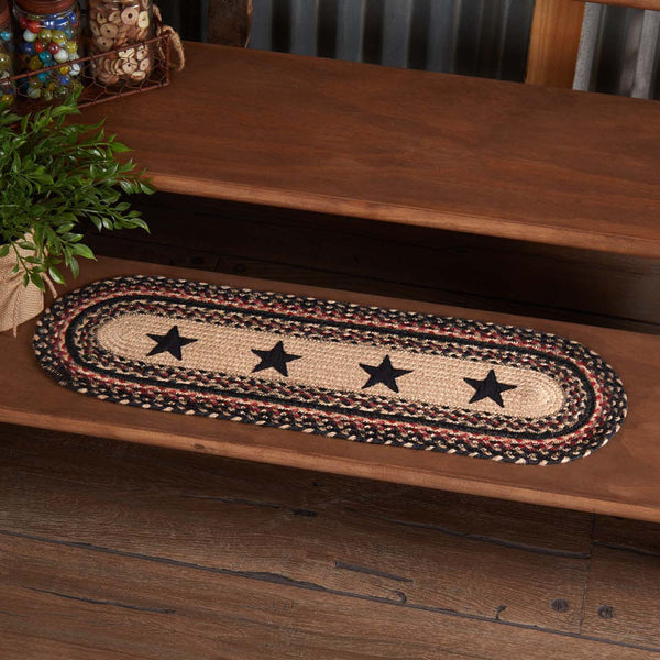 Colonial Star Jute Stair Tread Oval Latex 8.5x27, Woven braided jute wool blend fabrics in natural, country black, and bright red displayed in concentric circles surrounding a prominent Colonial Star applique. Visit website for FREE s/h & discount offers. Primitive Country Farmhouse Home Decor.