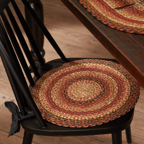 Add farmhouse fall charm with the Ginger Spice Jute Chair Pad. Braided terracotta, burgundy, and tan cushion with ties. Perfect for primitive dining décor.