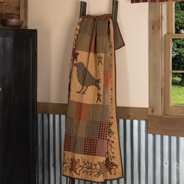 Bring primitive charm into your home with the Heritage Farms Quilted Throw featuring crow and star appliques, crimson plaid, mustard fabrics, and cozy fall style.