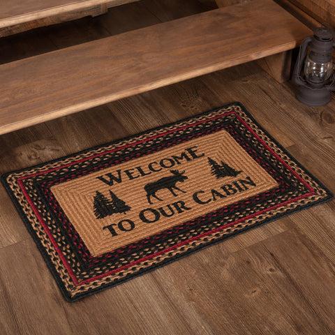 Cumberland Stenciled Moose Jute Rug Rect Welcome to the Cabin 20x30, chili pepper red, caviar black, and natural tan braids along the edge with a natural colored center proudly displaying the words "Welcome to our Cabin" with a moose and cedar trees stenciled in black. Primitive Country Farmhouse Home Decor.