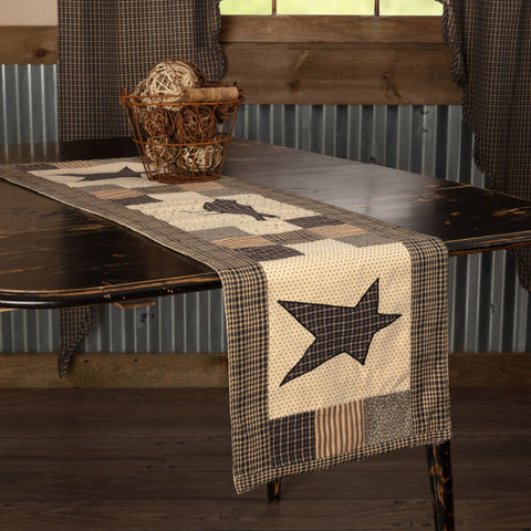 Kettle Grove Runner Crow and Star 13x48, Featuring assorted patchwork blocks in black, tan, charcoal and creme. A black and tan microcheck crow is proudly displayed in the center, Primitive Country Farmhouse Table Dining Kitchen Home Decor.