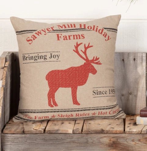 Sawyer Mill Reindeer Pillow 18x18 features a red reindeer stenciled in the center surrounded by Sawyer Mill Farms Holiday wording. Bring Joy, Since 1959, Tree Farm, Sleigh Rides, Hot Cocoa. Primitive Country Farmhouse Christmas Holiday Home Decor.