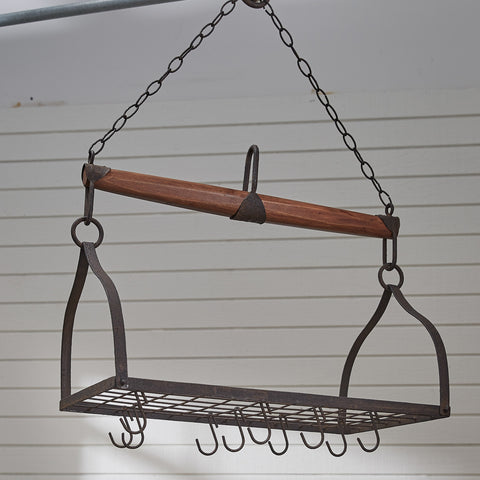 The design of the Wood & Iron Yoke Hanging Pot Rack is inspired by an antique cow yoke, and contains a metal grid with ten "S" hooks for pots and pans. Comes with a ceiling mount screw for hanging. Dimensions: 15.25"H x 15.75"D.