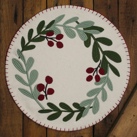 Our Cream Holiday Pitcher Candle Mat features a cream backbround with holly branches and is stiched around the edges for extra detail. Made of cotton. Measures 15 In diameter.