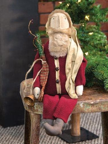 Santa is a primitive holiday doll with a fuzzy red suit, jingle bell buttons, and a tea-stained stocking hat.