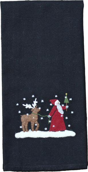 Our Christmas Friends Towel features detailled applique and embroidery of Father Christmas and his reindeer friend walking through a winter wonderland on a black ground.