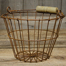 The Wire Egg Basket is a perfect farmhouse display piece for kitchen goods, eggs, towels, or soaps. Rusted metal wire basket with tapered sides and a weathered wooden handle. 6" H, 8" in diameter at lip, 4-1/2" at base. Visit website for free s/h and discount offers. Primitive country farmhouse home decor.