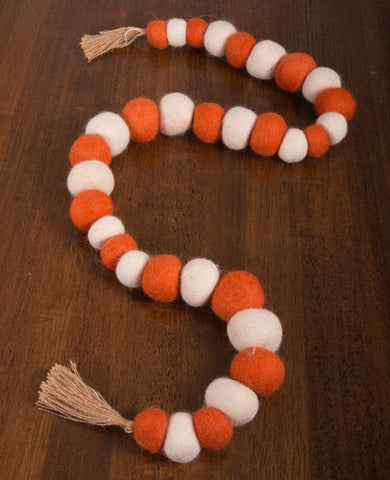Our Fall Garland White Orange garland is made of wool felt. this garland is 48 inches long. The unique design lends a distinctive touch.