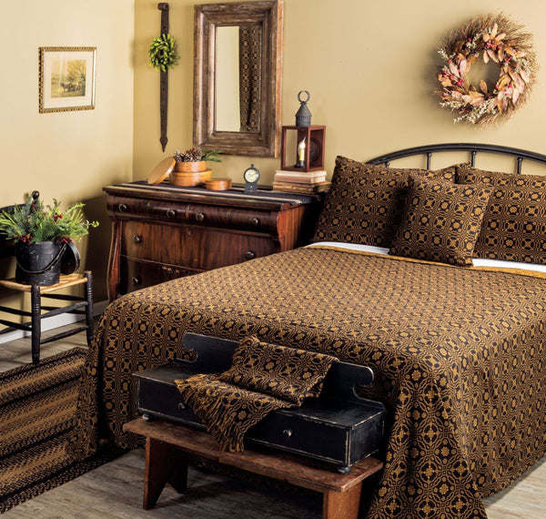 Exclusive king coverlet in black and mustard cotton jacquard. 97"x110". Features a woven Celtic lover’s knot for classic primitive bedroom style.