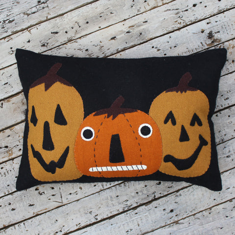 Jack-o-lanterns Felt Black Pillow is made of wool feltand features three pumpkin friends. Measures 14" x 20 Made of Wool Felt Fall Decor
