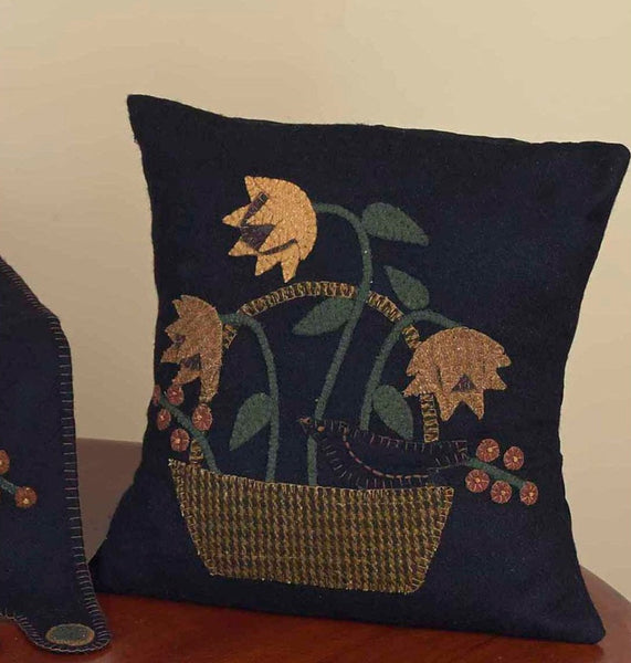 The black Crow In a Basket Pillow features an applique crow sitting in a basket of flowers. 