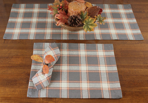 Fall sky placemat features a plaid of gray, orange, and cream in an evocative texture. 