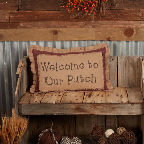 “Welcome to Our Patch” pillow from the Landon Collection, 14x22 burlap with plaid details in khaki, barn red, and chocolate brown. Final quantities available.