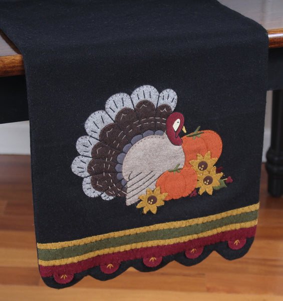 Turkey Time Wool Felt Table Runner featuresa  classic applique design on wool felt that creates an adorable home accent to celebrate the day of thanks