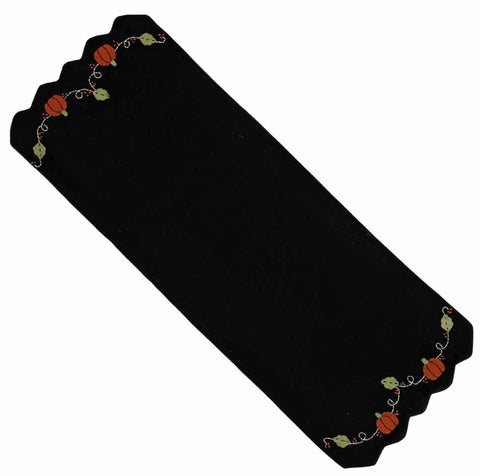 Pumpkins & Vines Black Table Runner features applique pumpkins with green vines on a black background, finished with scallopped edges.