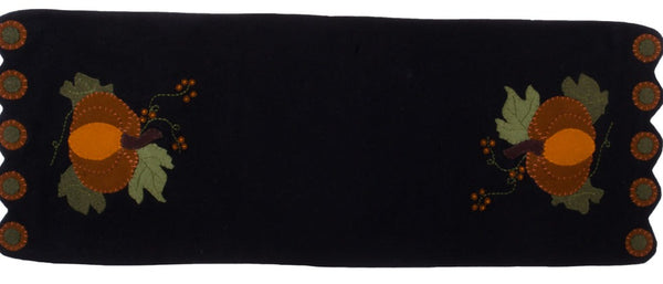 Pick A Pumpkin Runner features an applique pumpkin surround with leaves and a touch of pip berries on a black background, finsihed with scalloped edges.