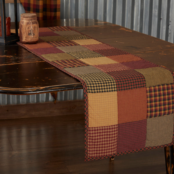 Heritage Farms Quilted Runner 13x48,  featuring red, yellow, and black patchwork. Primitive Country Farmhouse Kitchen Table Dining Home Decor.