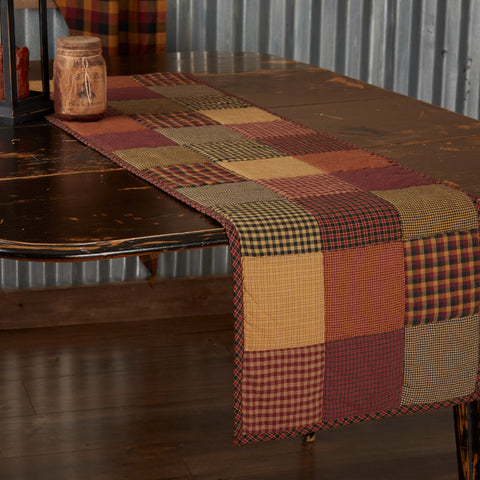 Heritage Farms Quilted Runner 13x48,  featuring red, yellow, and black patchwork. Primitive Country Farmhouse Kitchen Table Dining Home Decor.