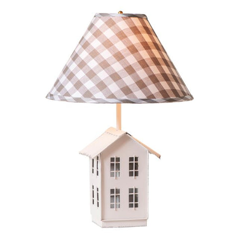 The nostalgic silhouette of a farmhouse perched on rolling hills meets a country aesthetic in this charming table lamp. The base is formed of a simple metal saltbox farmhouse, complete with four tiny windows on each side. Just above the roof, a 15-Inch gray check lampshade offers a soft glow to your favorite room or corner, gently shining down on the little house below.