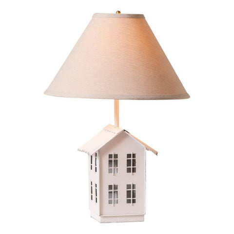 The nostalgic silhouette of a farmhouse perched on rolling hills meets a country aesthetic in this charming table lamp. The base is formed of a simple metal saltbox farmhouse, complete with four tiny windows on each side. Just above the roof, a classic 15-Inch ivory linen lampshade offers a soft glow to your favorite room or corner, gently shining down on the little house below.