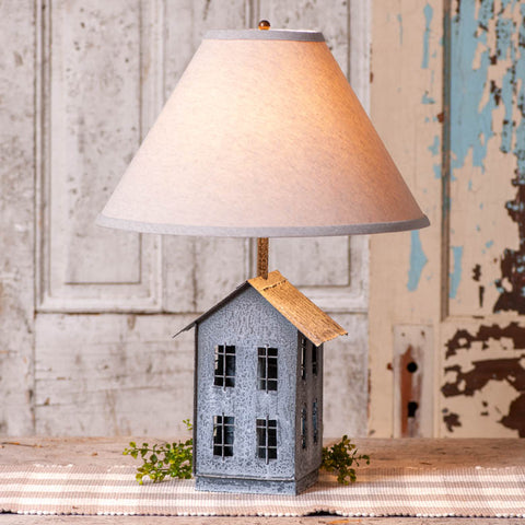 House Lamp with Ivory Linen Shad, the base is formed of a simple metal saltbox farmhouse, complete with four tiny windows on each side. Just above the roof, a classic 15-Inch ivory linen lampshade offers a soft glow to your favorite room or corner, gently shining down on the little house below. Primitive Country Farmhouse Home Decor Lighting.