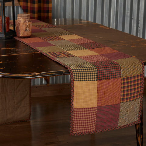 Heritage Farms Quilted Runner 13x90, featuring red, yellow, and black patchwork. Primitive Country Farmhouse Kitchen Table Dining Home Decor.