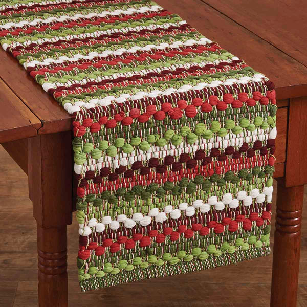 Boasting a unique design, our colorful Wintergreen Chindi Table Runner will brighten your holiday home, and the primitive design will add a little country flair to your seasonal decor! So versatile it can be used on any table throughout your home, as a centerpiece with your favorite candles, paired with other favorite seasonal decorative pieces...or wherever you need a little holiday cheer!