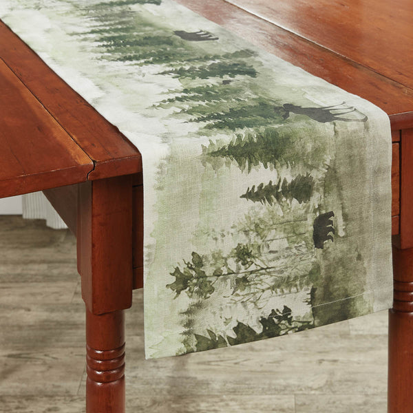 This Watercolor Wildlife Table Runner offers a beautiful outdoorsy appeal! Featuring a muted blend of grays and greens that work together to create a scene of animals in their natural habitats, this table runner is sure to bring the rugged outdoors in! Pair with the coordinating pillow, doormat, valance, placemats, napkins, and dishtowels for a complete look!