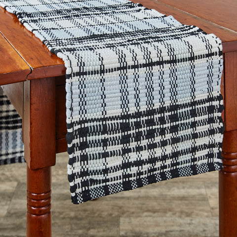 Add charming style to your table with the Refined Rustic Chindi Table Runner! Featuring a classic plaid design in tones of antique white, gray, and black, these table runners will be an elegant touch to your country decor! Complete the look with the rest of the Refined Rustic collection! Available in 3 sizes (each sold separately).