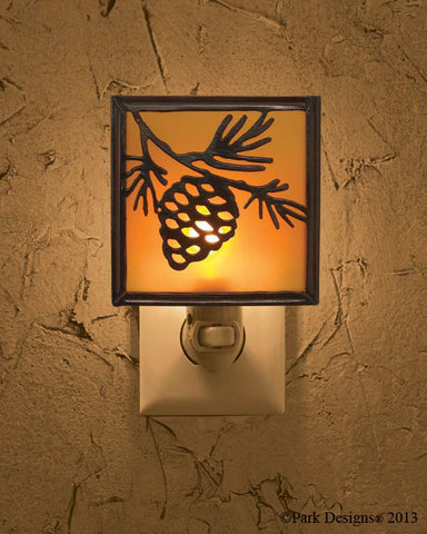 The Pinecone Night Light oozes rustic country charm! Reminiscent of the great outdoors, the night light is accented with pine cone clusters, needle tufts & branches in warm, outdoorsy tones! The wrought iron pieces in the collection offer the same outdoorsy accents that are perfect for your rustic country home!