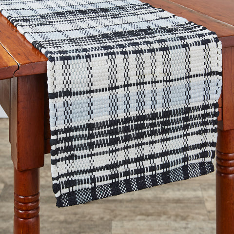 Add charming style to your table with the Refined Rustic Chindi Table Runner! Featuring a classic plaid design in tones of antique white, gray, and black, these table runners will be an elegant touch to your country decor! Complete the look with the rest of the Refined Rustic collection! Available in 3 sizes (each sold separately).
