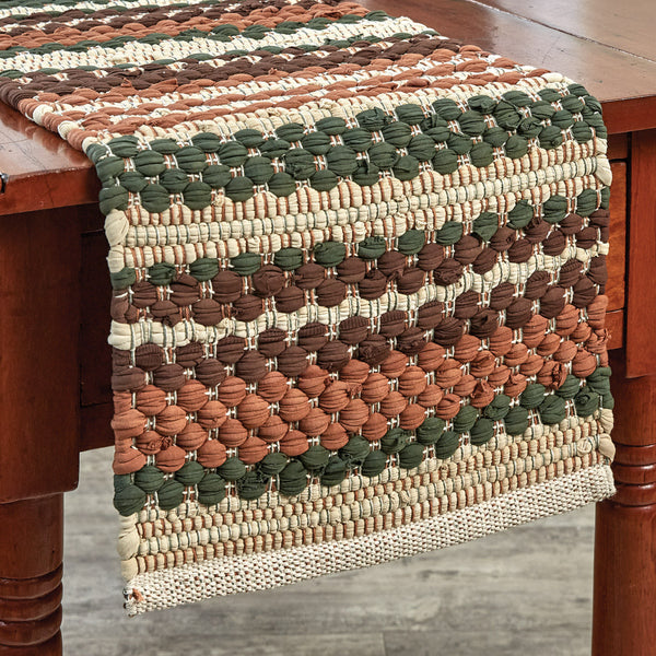Warm and lovely autumn shades of orange, green, brown, and tan blend together to provide a beautiful texture to your table with the Woodbourne Chindi Table Runners.