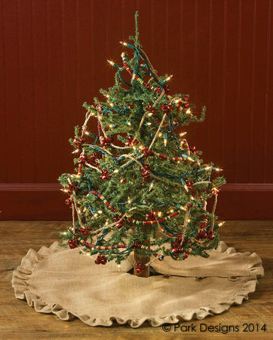 This Jute Burlap Tree Skirt in neutral burlap features ruffle trim and wood button closure details. Perfect addition to your rustic home for the Christmas season.