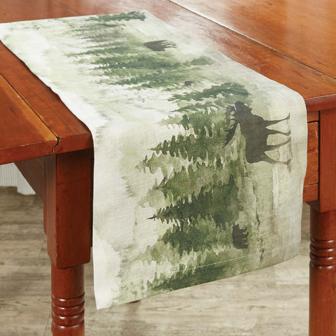 This Watercolor Wildlife Table Runner offers a beautiful outdoorsy appeal! Featuring a muted blend of grays and greens that work together to create a scene of animals in their natural habitats, this table runner is sure to bring the rugged outdoors in! Pair with the coordinating pillow, doormat, valance, placemats, napkins, and dishtowels for a complete look!