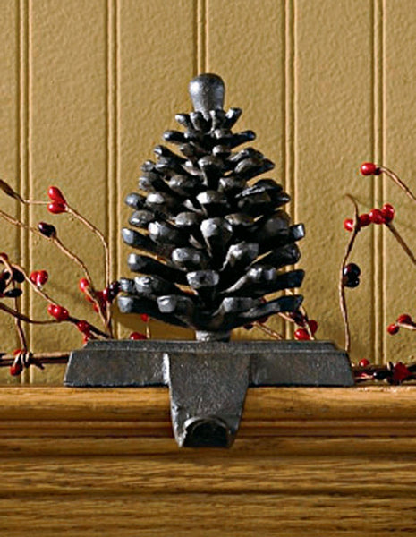And the stockings were hung by the chimney with care...Sporting an iron finish, this beautiful Pinecone Stocking Hanger will be happy to hold your favorite Christmas stocking! So versatile...use on a mantel, table, or any ledge in your home! 