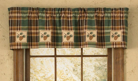 The Wood River Pinecone Patch Lined Valance spruces up any window! Featuring a savory blend of chocolate, tan & green tones in a pretty plaid, it oozes country charm! It is further enhanced with pine cones & branches that are whip-stitched onto a sand-colored patch! Perfect on their own, or pair with coordinating tiers for a more striking appeal!
