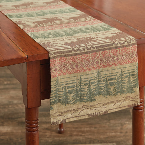 The Moose Jacquard Table Runner offer a beautiful outdoorsy appeal! Featuring a blend of neutral colors and a pop of red that work together to create a breathtaking scene of moose in their natural habitat, this table runner is sure to bring the rugged outdoors in! Coordinate with the complementary Moose Jacquard kitchen linens and curtains to complete the look! Available in two sizes (sold separately).